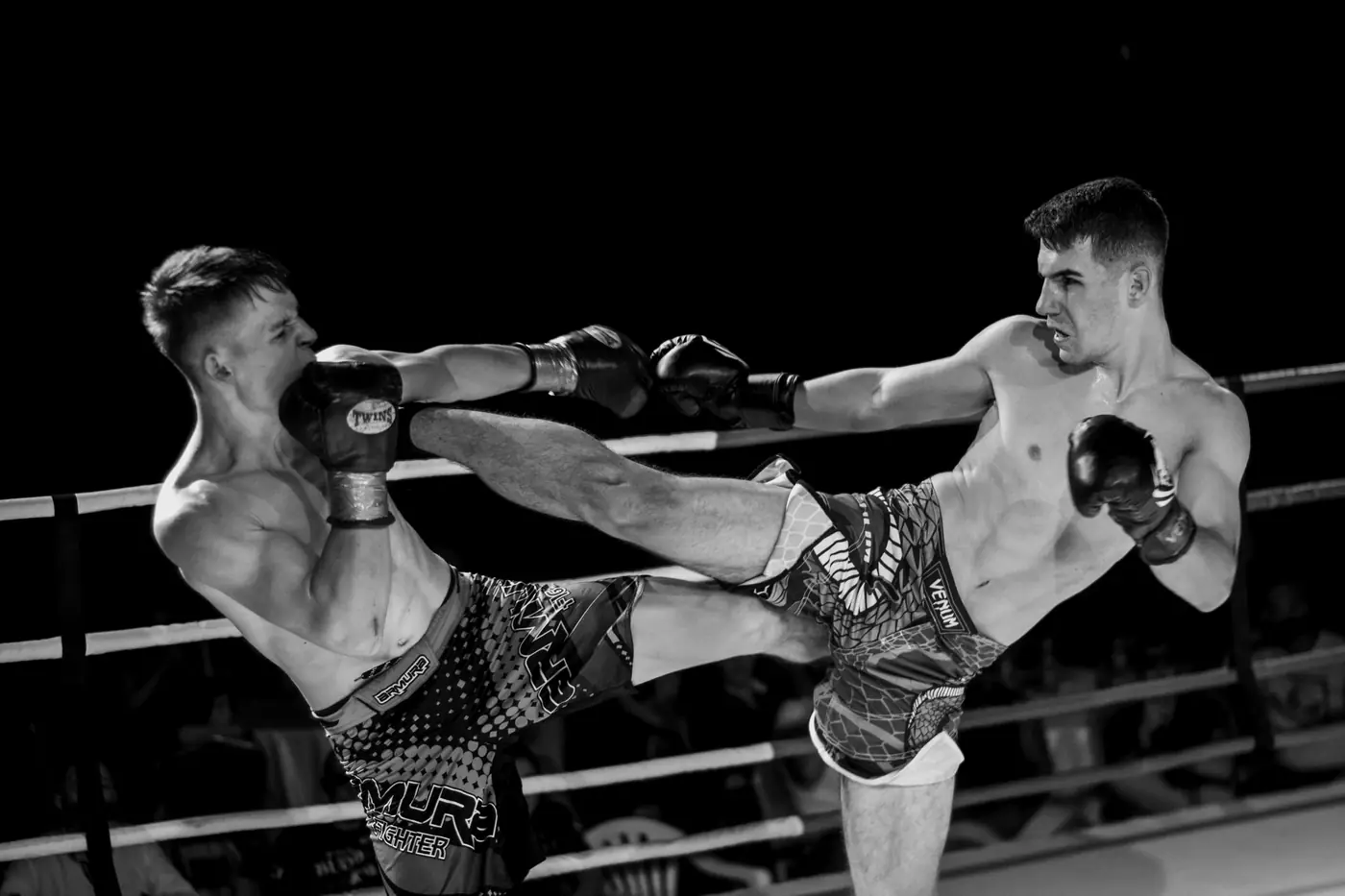 Two kickboxers exchange strikes in the ring